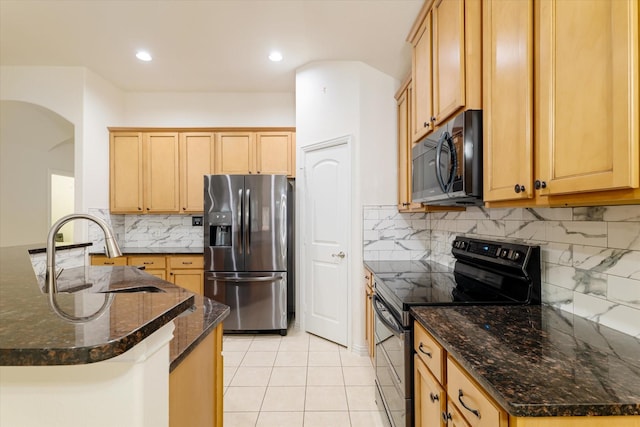 505 Osage Dr, Mckinney, TX 75071 - kitchen featuring black appliances, a sink, arched walkways, light tile patterned floors, and tasteful backsplash