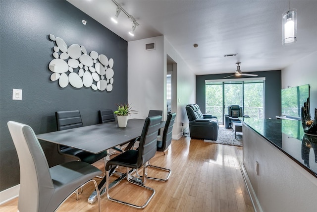4414 Cedar Springs Rd Unit 209, Dallas, TX 75219 - dining area with light wood-style floors, baseboards, ceiling fan, and track lighting