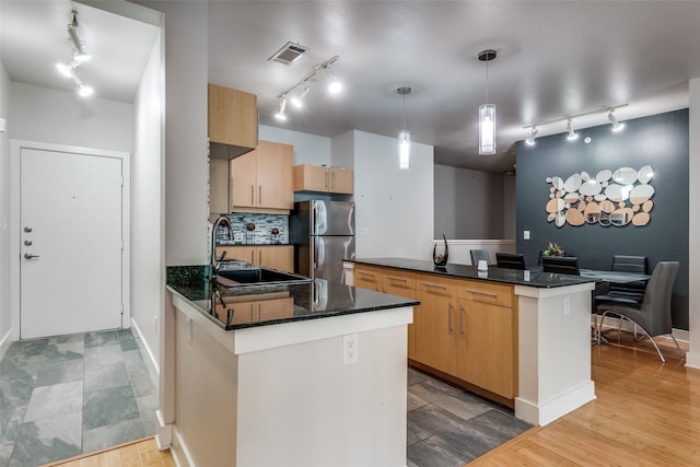 4414 Cedar Springs Rd Unit 209, Dallas, TX 75219 - kitchen with track lighting, freestanding refrigerator, and a sink