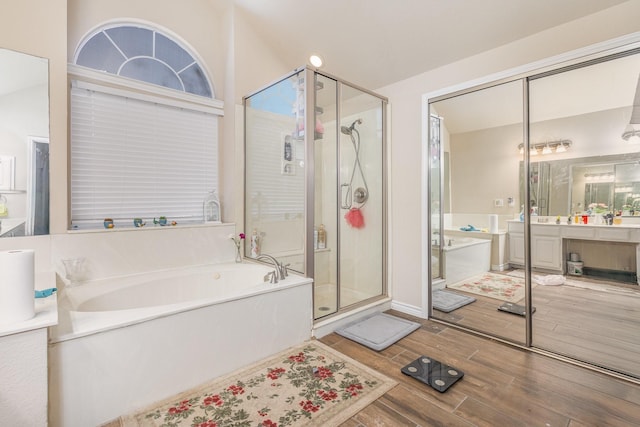 7013 Caldwell Ln, Plano, TX 75025 - bathroom with a garden tub, a stall shower, wood finished floors, and vanity