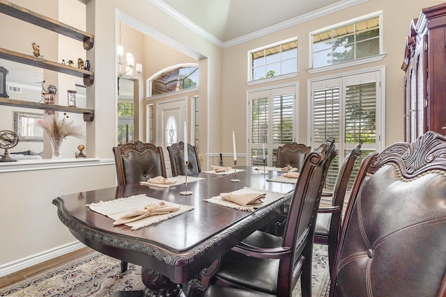 7013 Caldwell Ln, Plano, TX 75025 - dining area with plenty of natural light, ornamental molding, wood finished floors, baseboards, and a chandelier