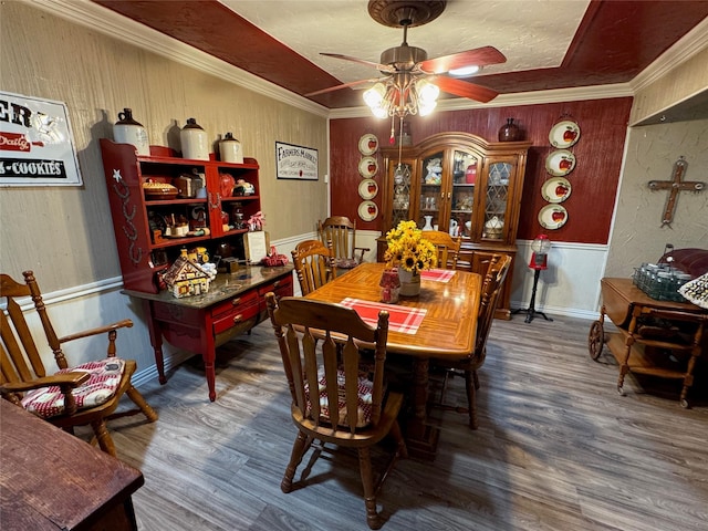 5016 Wyoming Trl, North Richland Hills, TX 76180 - dining area with ceiling fan, wood finished floors, wooden walls, and crown molding