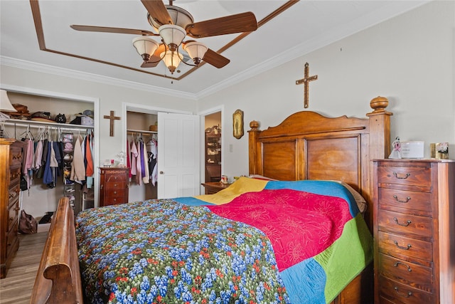 5016 Wyoming Trl, North Richland Hills, TX 76180 - bedroom with two closets, crown molding, wood finished floors, and a ceiling fan
