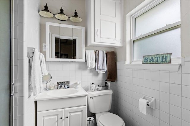 5016 Wyoming Trl, North Richland Hills, TX 76180 - bathroom featuring toilet, vanity, and tile walls