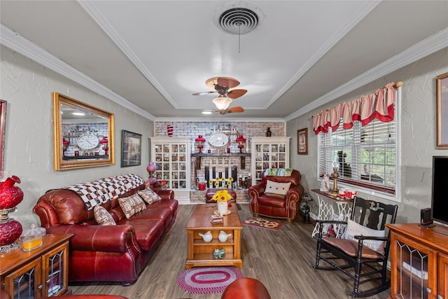 5016 Wyoming Trl, North Richland Hills, TX 76180 - living area featuring wood finished floors, ceiling fan, a raised ceiling, and ornamental molding