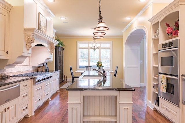kitchen with a sink, stainless steel appliances, a warming drawer, open shelves, and crown molding