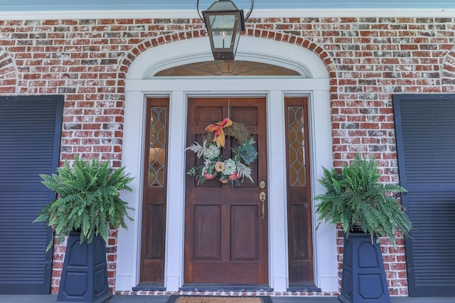property entrance featuring brick siding