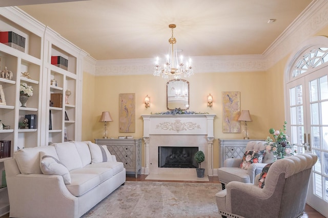 living room featuring plenty of natural light, wood finished floors, a chandelier, ornamental molding, and a fireplace with flush hearth