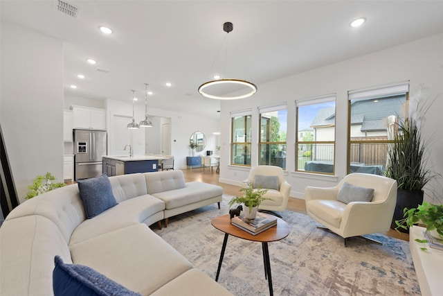 13037 Cabana Dr, Frisco, TX 75035 - living room featuring recessed lighting, light wood-style floors, and baseboards