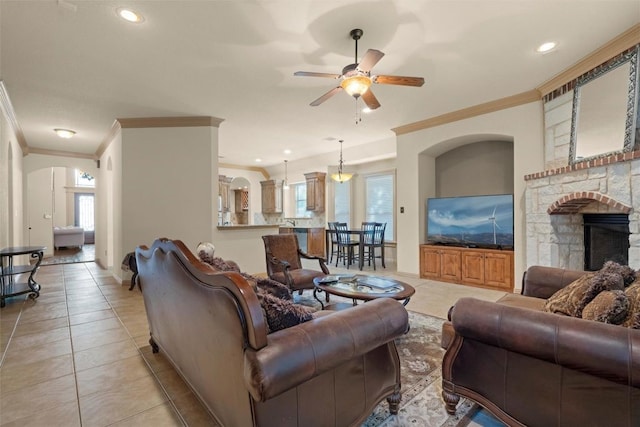 6725 S Fork Dr, North Richland Hills, TX 76182 - living room with ornamental molding, a ceiling fan, light tile patterned flooring, a stone fireplace, and recessed lighting
