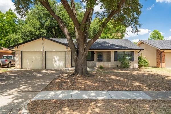 2309 Ruby Rd, Irving, TX 75060 - single story home with brick siding, an attached garage, and driveway
