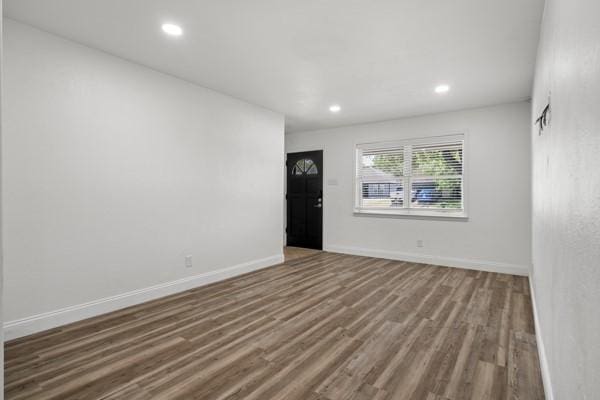 2309 Ruby Rd, Irving, TX 75060 - unfurnished living room featuring wood finished floors, recessed lighting, and baseboards