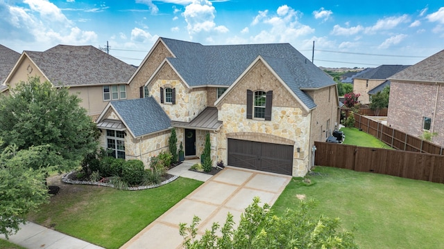 4533 Cheetah Trl, Frisco, TX 75034 - view of front of home with stone siding, concrete driveway, an attached garage, a standing seam roof, and metal roof