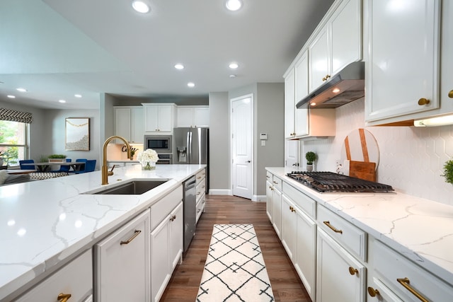4533 Cheetah Trl, Frisco, TX 75034 - kitchen with a sink, under cabinet range hood, stainless steel appliances, white cabinets, and recessed lighting