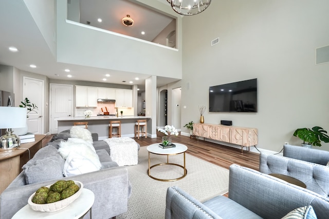 4533 Cheetah Trl, Frisco, TX 75034 - living area featuring dark wood finished floors, a chandelier, baseboards, a high ceiling, and recessed lighting