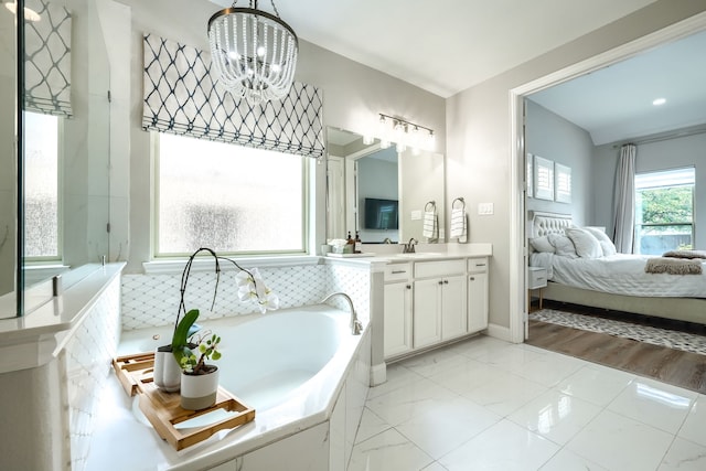 4533 Cheetah Trl, Frisco, TX 75034 - full bath with vanity, a garden tub, ensuite bathroom, a chandelier, and baseboards