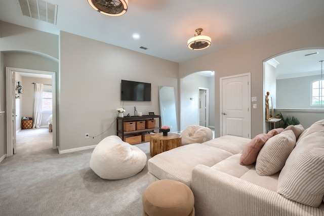 4533 Cheetah Trl, Frisco, TX 75034 - living area featuring arched walkways, light carpet, and baseboards