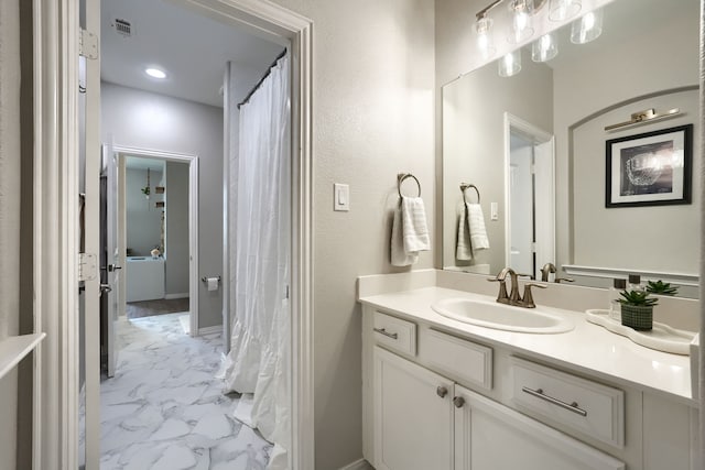 4533 Cheetah Trl, Frisco, TX 75034 - bathroom with marble look tile flooring, vanity, and baseboards