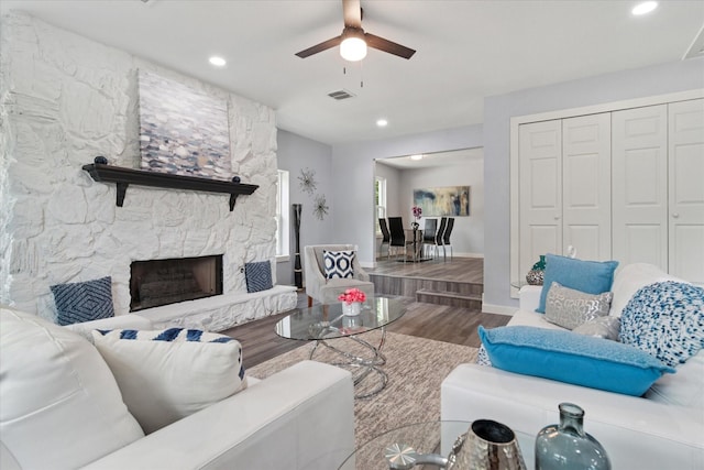 living room with wood finished floors, a ceiling fan, recessed lighting, baseboards, and a fireplace