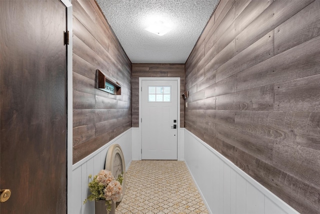 308 W Spring Valley Dr, Hewitt, TX 76643 - doorway with a textured ceiling, wooden walls, and wainscoting