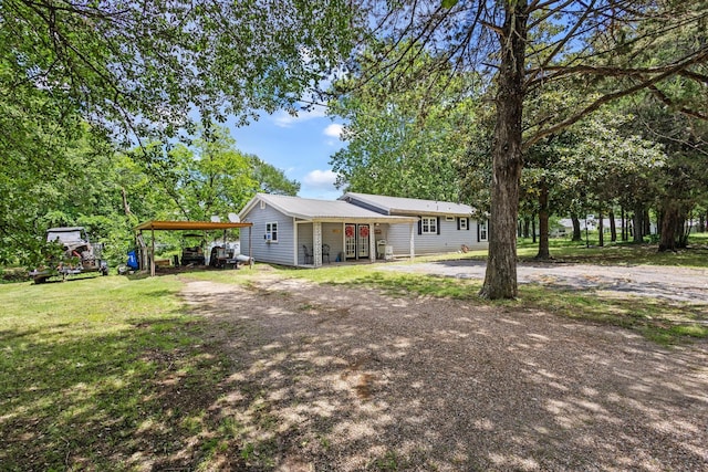 1801 Beavers Pt, Bonham, TX 75418 - ranch-style house featuring driveway, a detached carport, a front yard, and metal roof