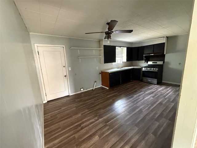701 Perry, Santa Anna, TX 76878 - kitchen with gas stove, dark cabinets, ceiling fan, a sink, and dark wood-type flooring