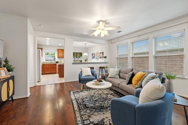 7735 Whirlwind Dr, Frisco, TX 75036 - living area featuring a ceiling fan, light wood finished floors, and baseboards