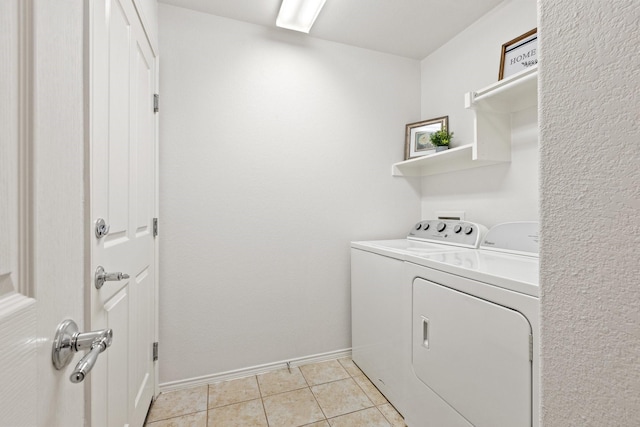 7735 Whirlwind Dr, Frisco, TX 75036 - washroom with washer and clothes dryer, baseboards, and light tile patterned floors