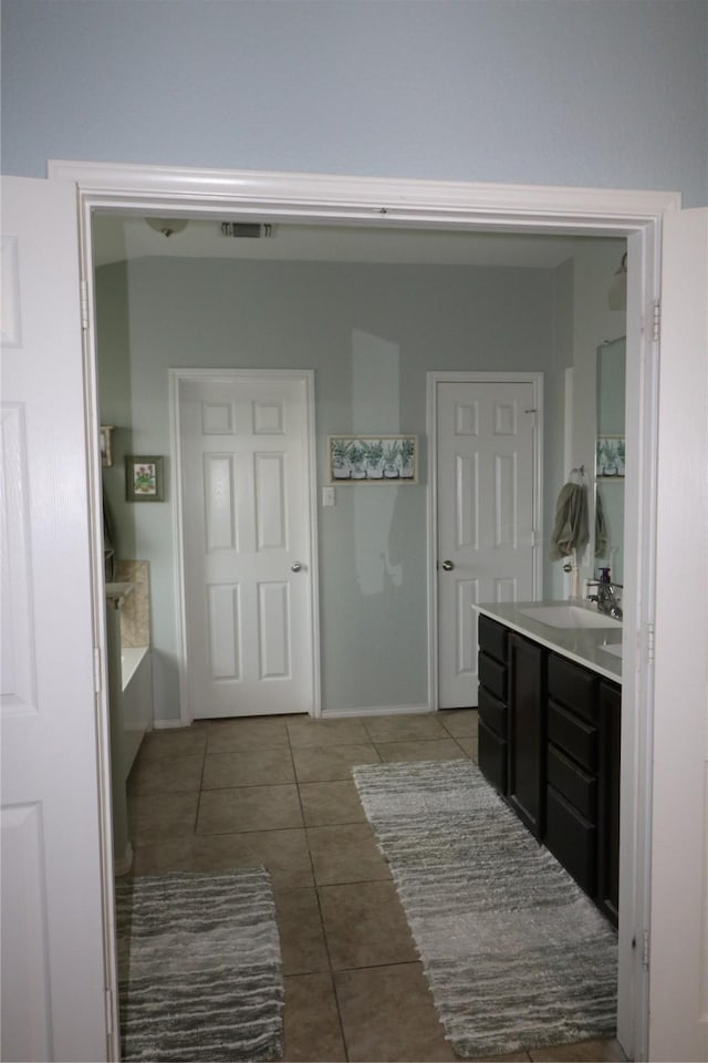 5516 Tama Dr, Waco, TX 76708 - full bathroom featuring tile patterned flooring, vanity, and baseboards