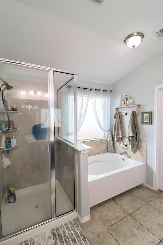 5516 Tama Dr, Waco, TX 76708 - bathroom with a garden tub, tile patterned floors, and a shower stall