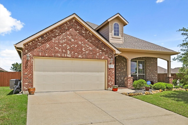 5139 Crystal Lake Ave, Krum, TX 76249 - traditional-style house featuring driveway, brick siding, an attached garage, and roof with shingles