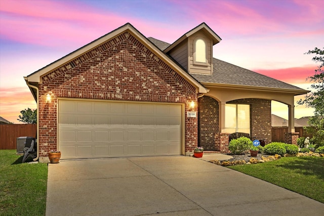 5139 Crystal Lake Ave, Krum, TX 76249 - view of front of house with brick siding, a garage, driveway, and roof with shingles