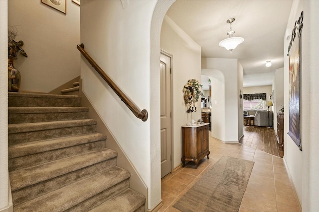 5139 Crystal Lake Ave, Krum, TX 76249 - stairs featuring arched walkways, tile patterned flooring, and baseboards