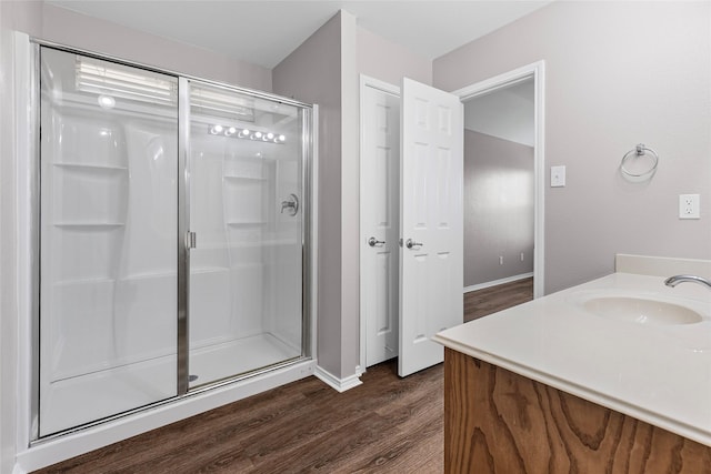 1502 Jacksons Run, Greenville, TX 75402 - bathroom with a stall shower, wood finished floors, vanity, and baseboards