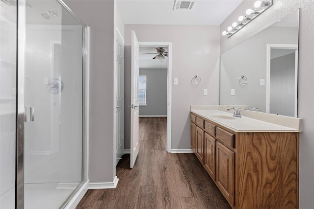 1502 Jacksons Run, Greenville, TX 75402 - full bathroom with wood finished floors, a shower stall, vanity, and baseboards