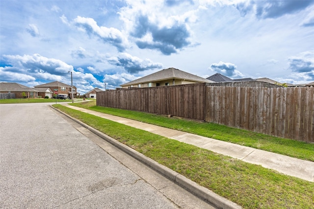 1502 Jacksons Run, Greenville, TX 75402 - view of asphalt road featuring sidewalks, curbs, a residential view, and traffic signs