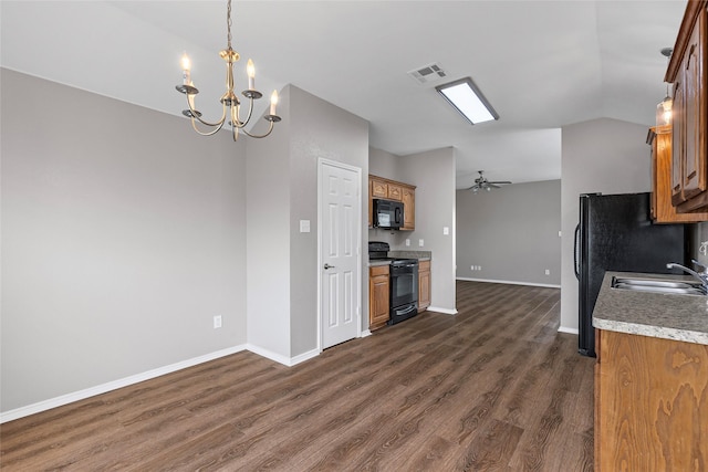 1502 Jacksons Run, Greenville, TX 75402 - kitchen with black appliances, brown cabinetry, baseboards, a sink, and a chandelier