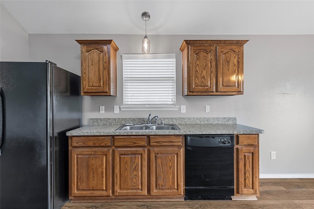 1502 Jacksons Run, Greenville, TX 75402 - kitchen with black appliances, a sink, dark wood finished floors, brown cabinets, and baseboards