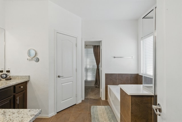 10957 Colonial Heights Ln, Fort Worth, TX 76179 - full bath featuring vanity, a garden tub, tile patterned flooring, and baseboards