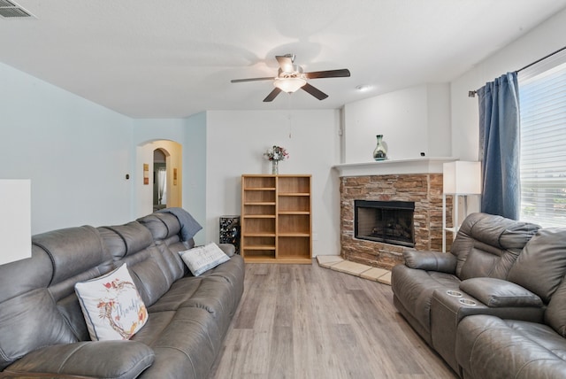 10957 Colonial Heights Ln, Fort Worth, TX 76179 - living area with a ceiling fan, arched walkways, light wood-style flooring, and healthy amount of natural light