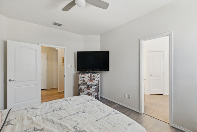 10957 Colonial Heights Ln, Fort Worth, TX 76179 - bedroom featuring wood finished floors, a ceiling fan, and baseboards