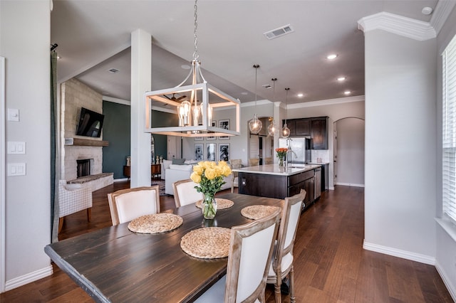 13400 Summer Moon Trl, Ponder, TX 76259 - dining space featuring baseboards, a fireplace, crown molding, dark wood-type flooring, and recessed lighting