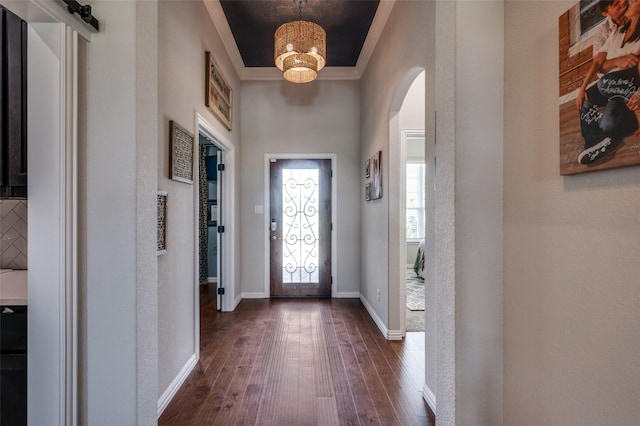13400 Summer Moon Trl, Ponder, TX 76259 - foyer entrance featuring arched walkways, dark wood-type flooring, crown molding, and baseboards