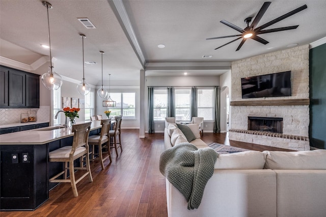 13400 Summer Moon Trl, Ponder, TX 76259 - living room with a ceiling fan, crown molding, dark wood-type flooring, a fireplace, and baseboards