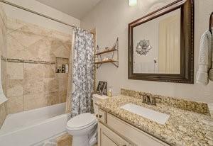 2575 Wincrest Dr, Rockwall, TX 75032 - bathroom with toilet, vanity, and shower / bath combo with shower curtain