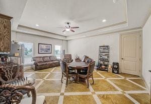 2575 Wincrest Dr, Rockwall, TX 75032 - dining space featuring a raised ceiling, ceiling fan, inlaid floor details, recessed lighting, and crown molding