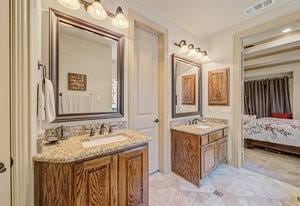 2575 Wincrest Dr, Rockwall, TX 75032 - ensuite bathroom featuring two vanities and marble look tiles