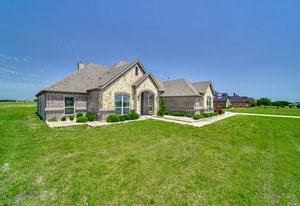 2575 Wincrest Dr, Rockwall, TX 75032 - french country home with a front yard and a chimney