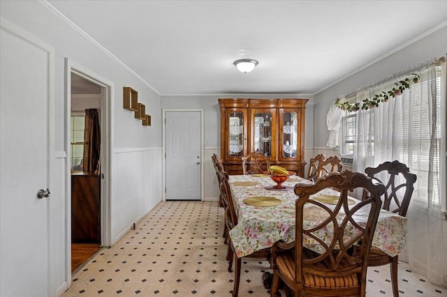 116 S Barron St, Arp, TX 75750 - dining area featuring ornamental molding, a wainscoted wall, and light flooring