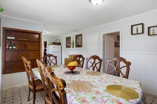 116 S Barron St, Arp, TX 75750 - dining space featuring a decorative wall, ornamental molding, and wainscoting